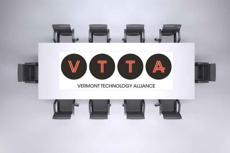 Overhead view of table and chairs with VTTA logo superimosed on table