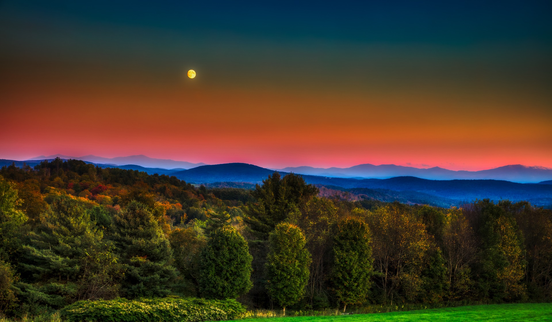 Vermont view of trees and mountains at sunset.