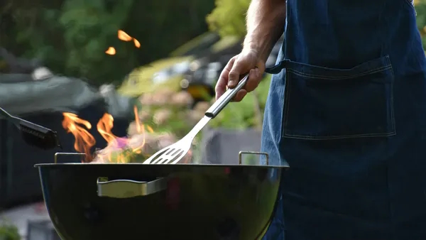 A person cooking on a barbecue grill