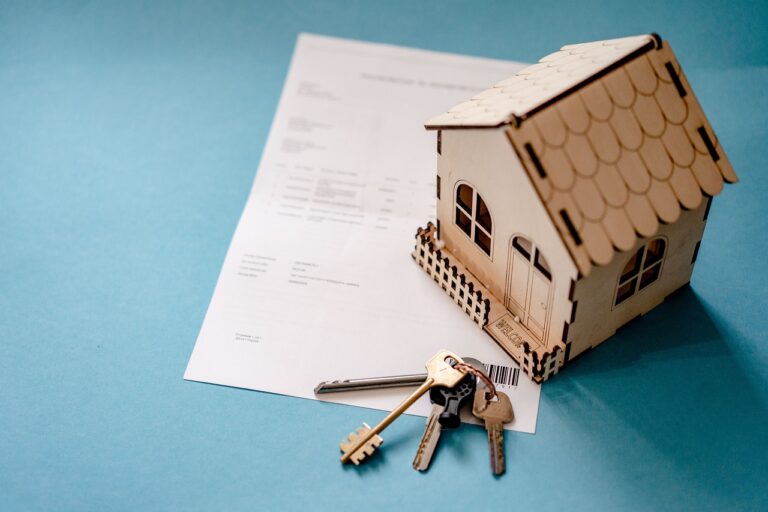 real estate image showing a miniature house, keys and contact